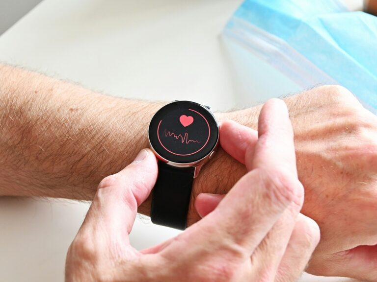 Photo of a smartwatch displaying heart rate tracking being worn on a wrist
