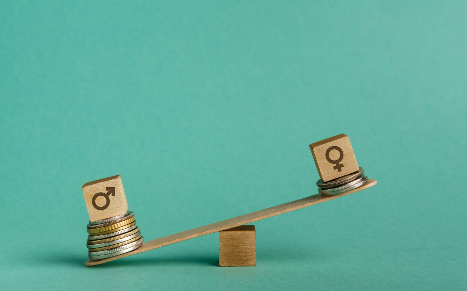 Feature photo by Prostock Studio/AdobeStock Illustration of gender pay gap with money and seesaw