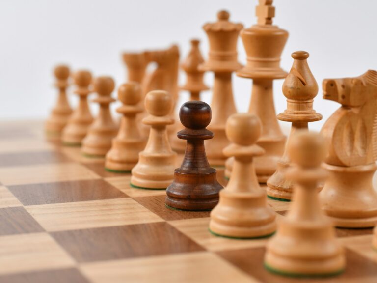 ©Randy Fath / Unsplash One dark brown chess piece stands out on a board of light brown chess pieces