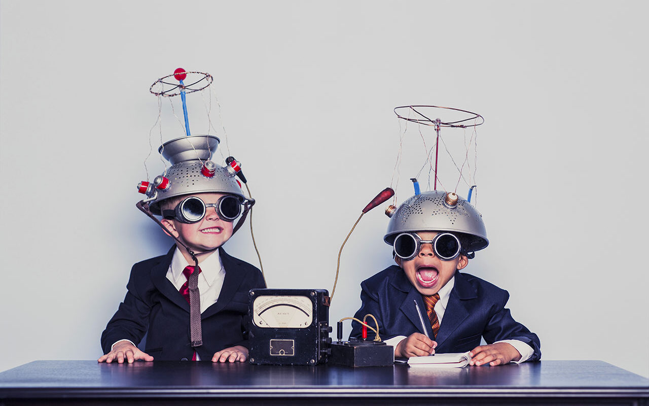 © Rich Vintage / Gettyimages Boys Dressed as Businessmen Wearing Mind Reading Helmets,