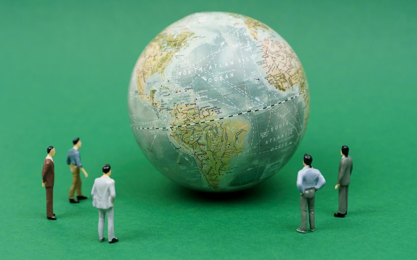 ©SkazovD / Shutterstock Image of five male figurines looking at a globe.