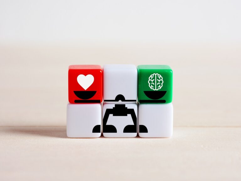 Blocks showing a scale that balances a heart on one side and a brain on the other
