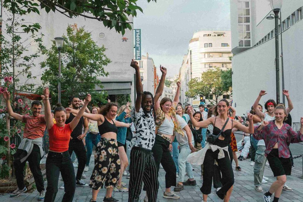 Group of people dancing in a city street