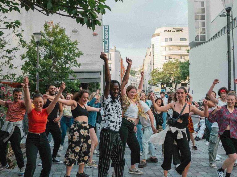 Group of people dancing in a city street