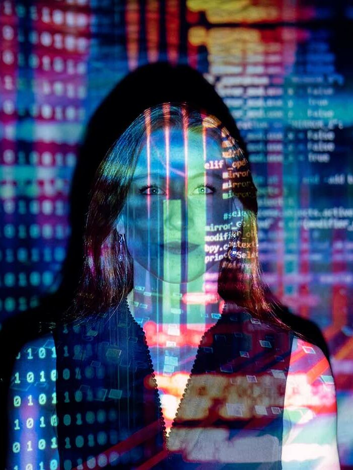 ©thisisengineering-raeng/Unsplash Women in tech and science. Photo of a woman with code projected on to her face.