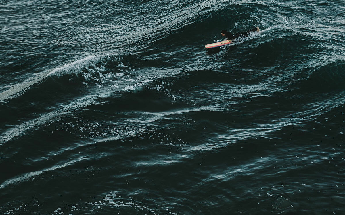 ©Tim Mossholder/Unsplash Photo of a surfer in the ocean.