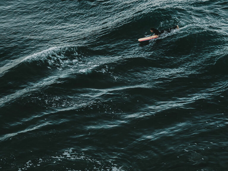 Photo of a surfer in the ocean.