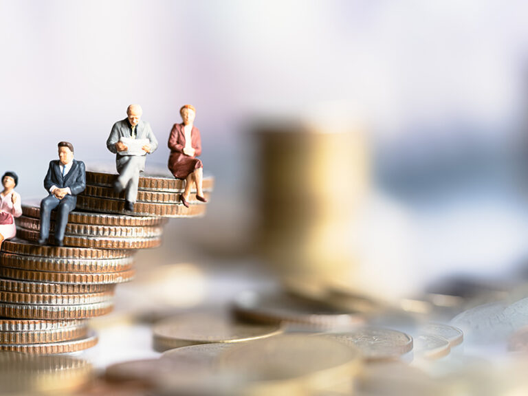 Miniature people: Elderly people sitting on coins stack.