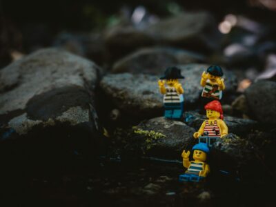 Lego characters dressed as pirates are navigating a rocky landscape