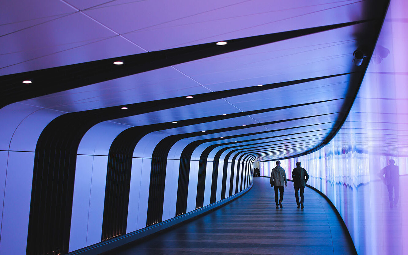 © Tom Parkes / Unsplash Man walking through pathway, © Tom Parkes / Unsplash