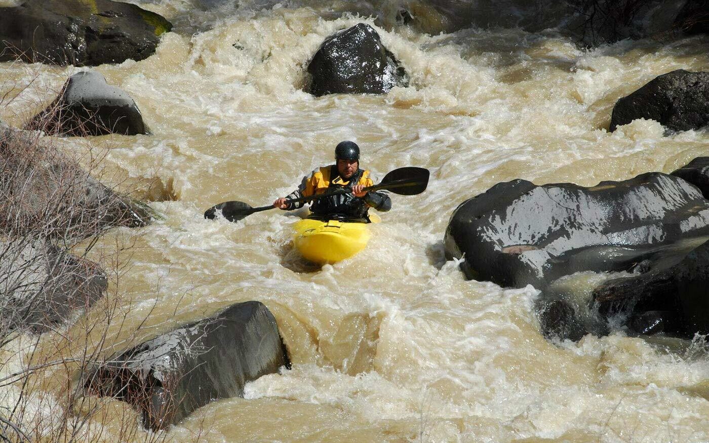 ©Tom Spross/Unsplash Man white water kayaking.
