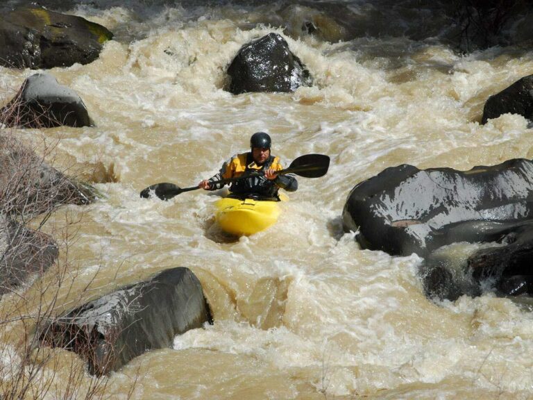 Man white water kayaking.