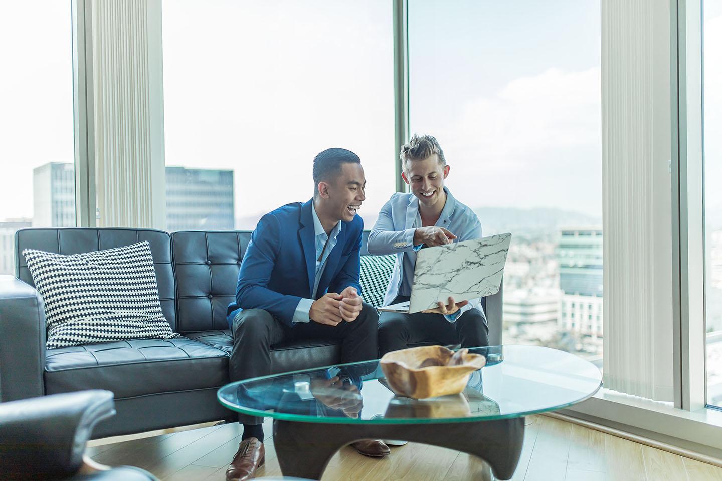 Photo by Austin Distel on Unsplash. Two businessmen working together.