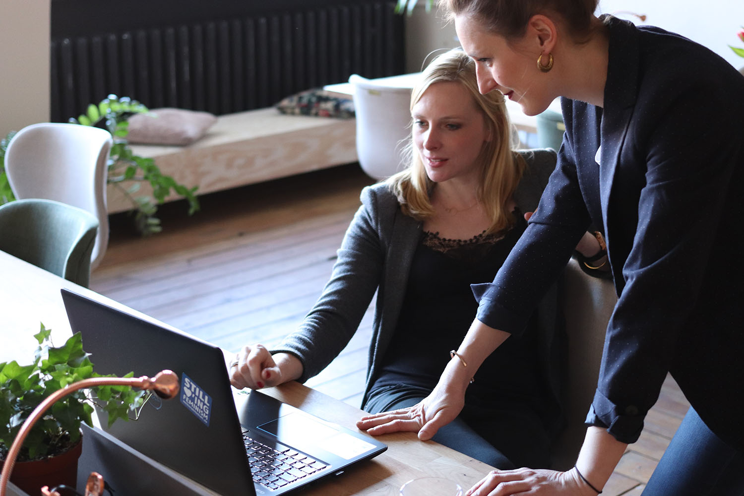 Photo by CoWomen on Unsplash. Two women working together.