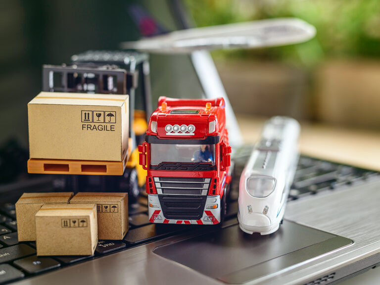 Transport truck, air plane, hi-speed train, fork-lift moves a box / cartons on laptop computer, depicts delivering goods or products