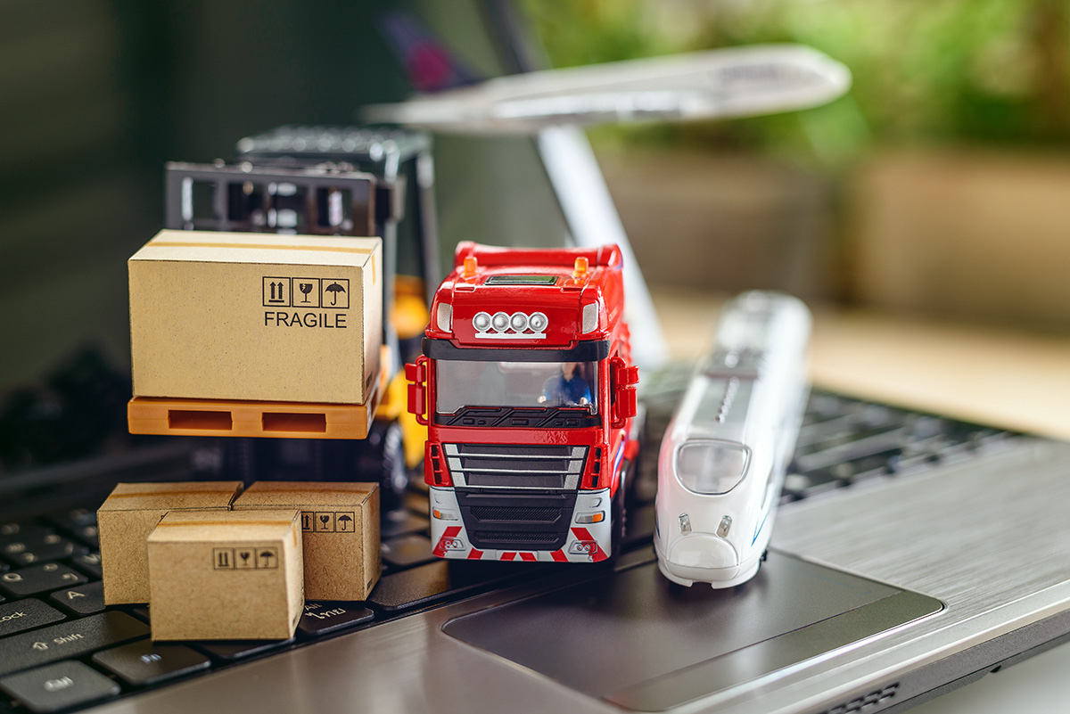 Transport truck, air plane, hi-speed train, fork-lift moves a box / cartons on laptop computer, depicts delivering goods or products