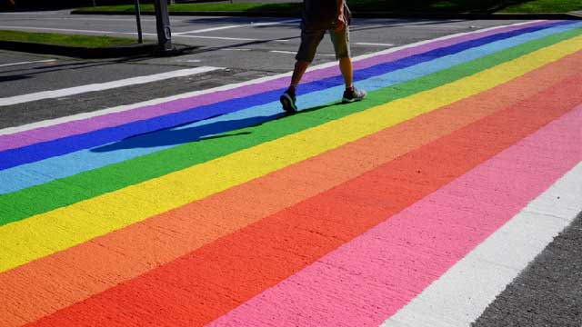 The rainbow flag painted on a street